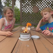 A young girl and boy make s'mores and extinguish the portable Abeego mini campfire